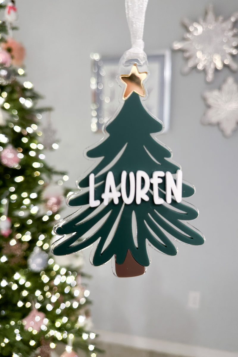 Close-up of personalized acrylic Christmas tree ornament | Buffy + Coco